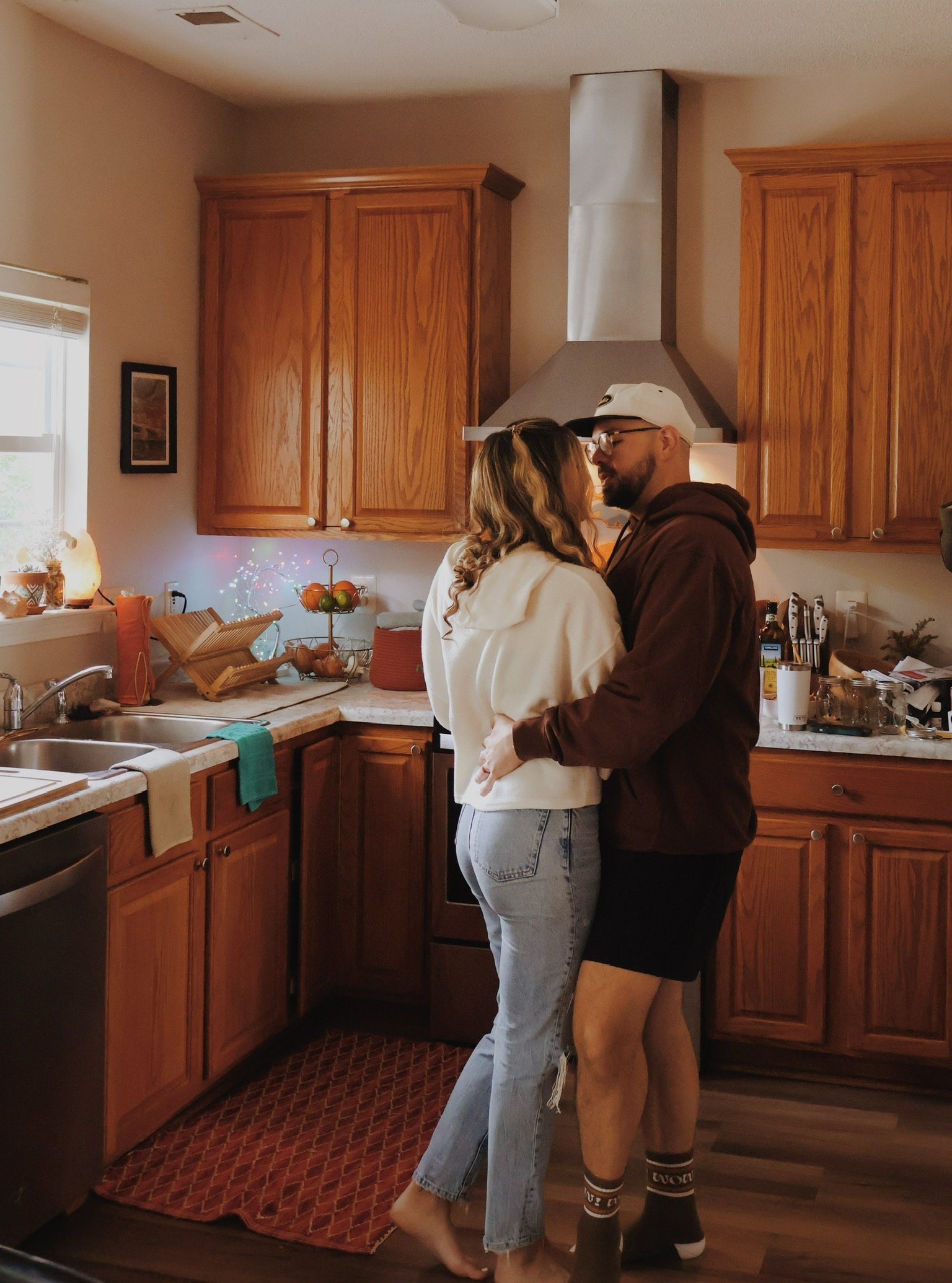 Nicole and Ian slow-dancing in the kitchen.